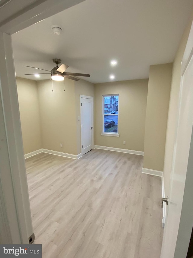 unfurnished room featuring light wood-type flooring and ceiling fan