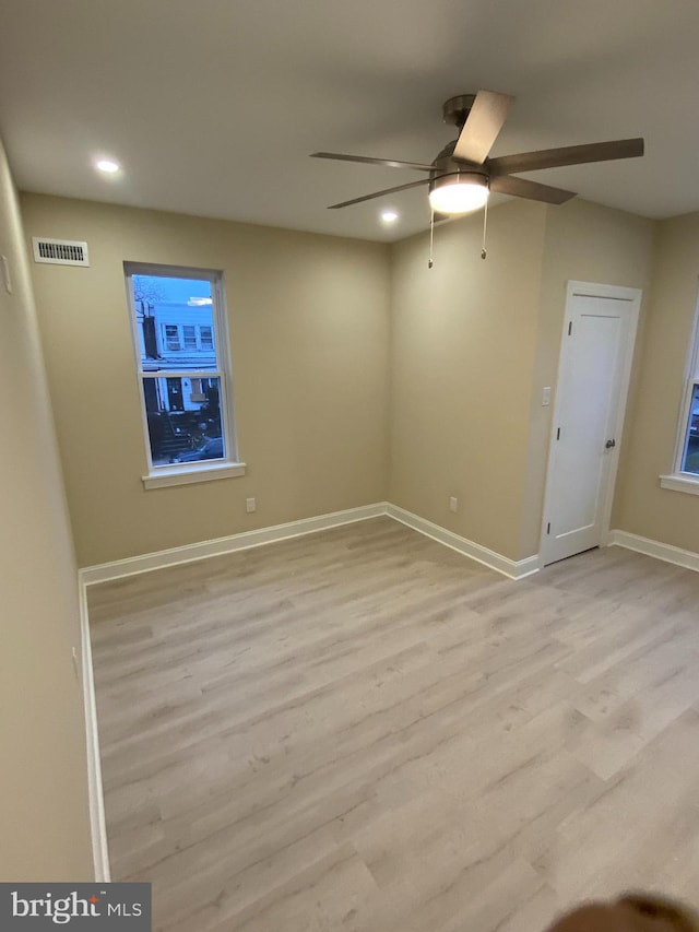 unfurnished room with light wood-type flooring and ceiling fan