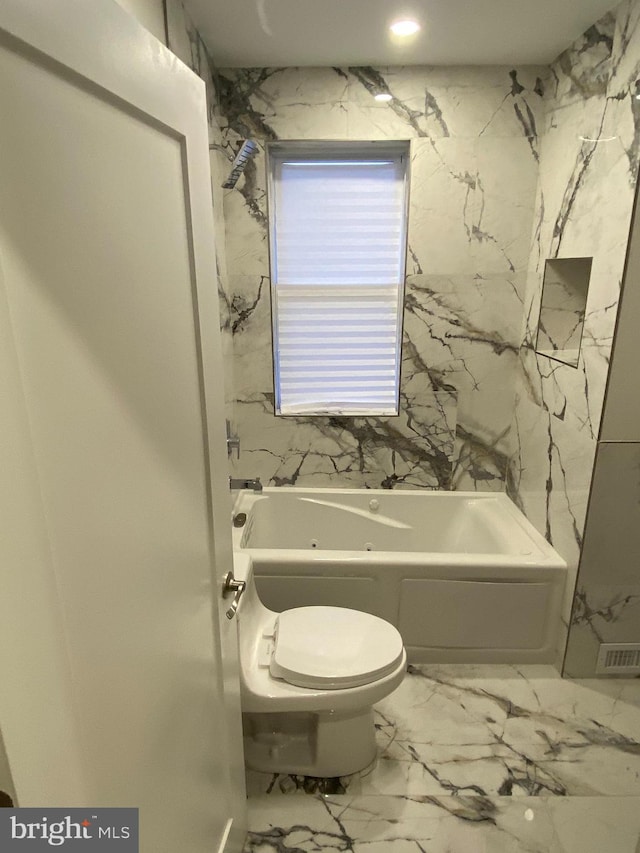 bathroom featuring a bathtub and toilet