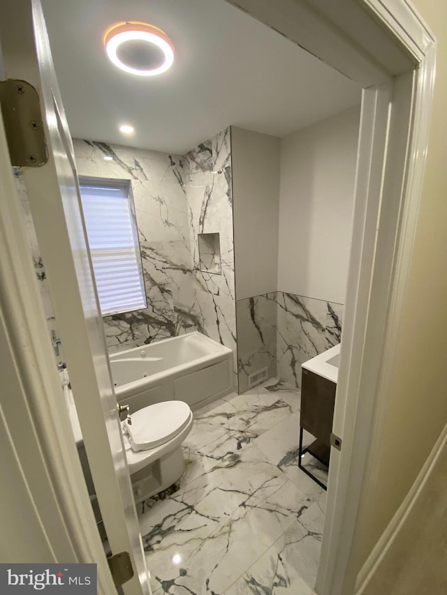 bathroom featuring tile walls, vanity, and toilet