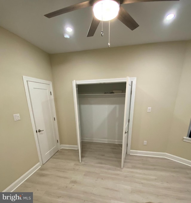 unfurnished bedroom featuring ceiling fan and light wood-type flooring