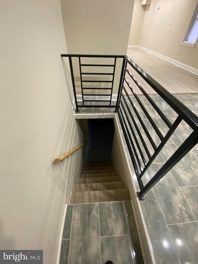 stairs featuring wood-type flooring