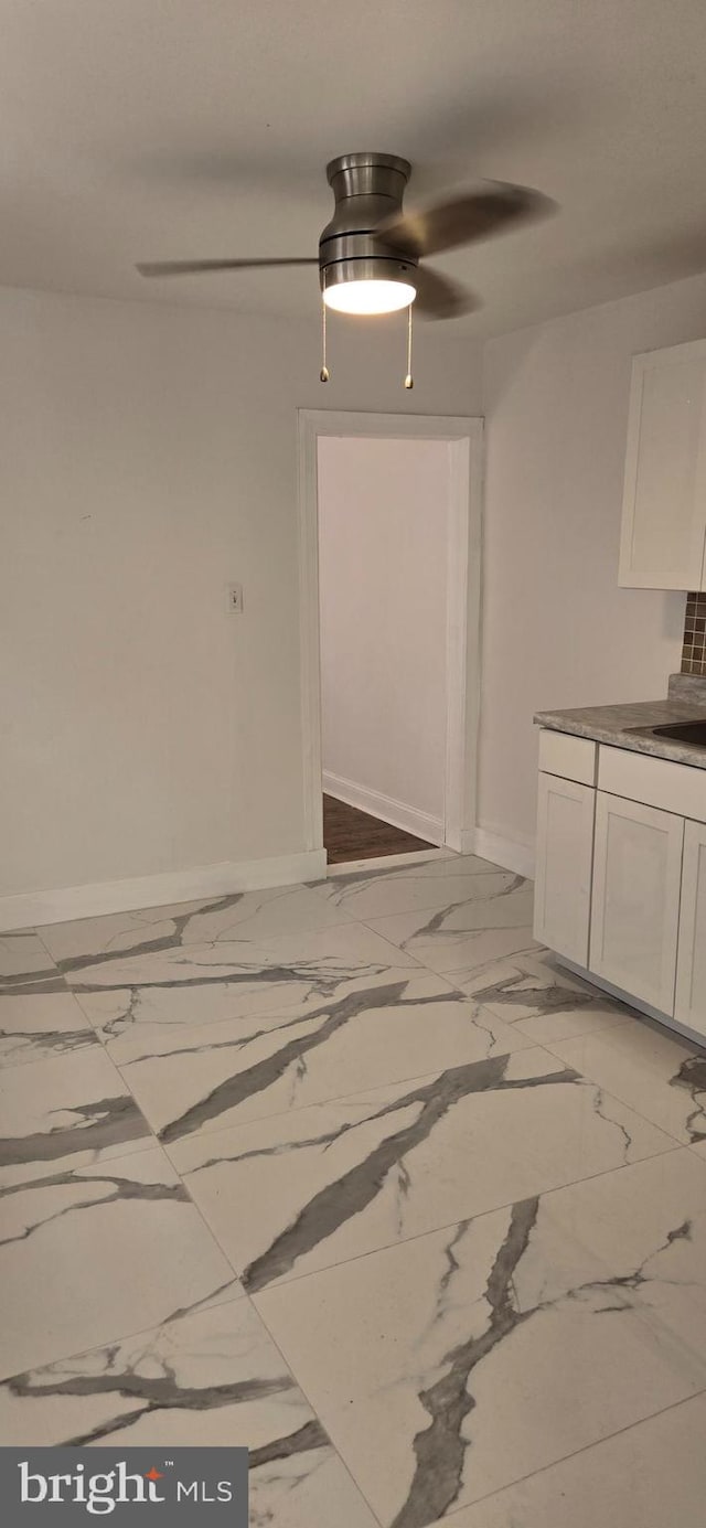 unfurnished dining area featuring ceiling fan