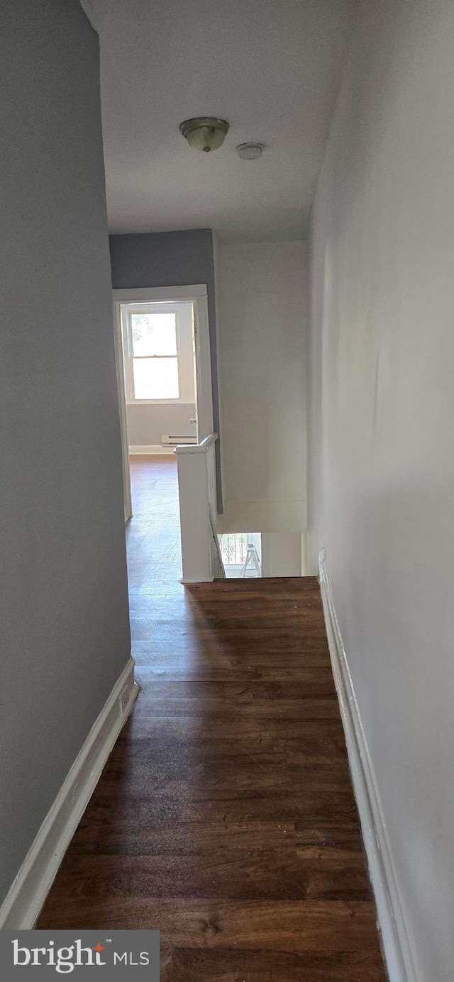 corridor featuring dark wood-type flooring