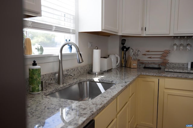 kitchen with sink and light stone counters