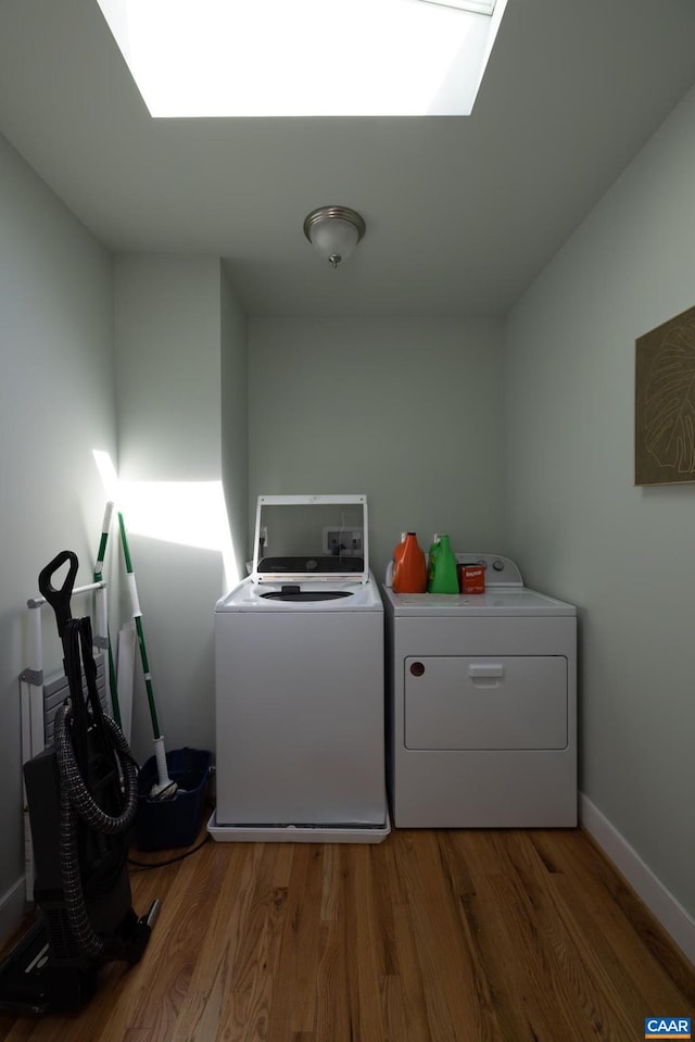 laundry room featuring wood-type flooring and washing machine and clothes dryer