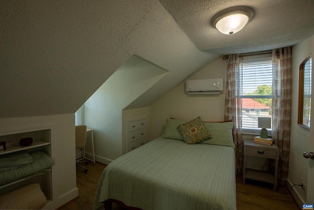 bedroom featuring a textured ceiling, dark wood-type flooring, a wall mounted air conditioner, and lofted ceiling