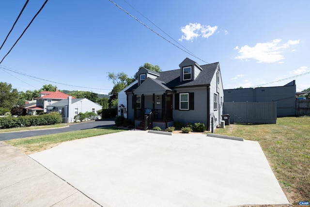 bungalow featuring a front yard and covered porch