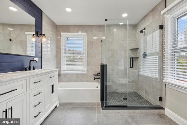 bathroom featuring vanity, shower with separate bathtub, and tile patterned flooring