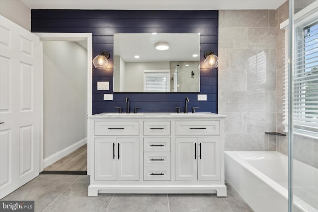 bathroom featuring tile patterned flooring, independent shower and bath, and vanity