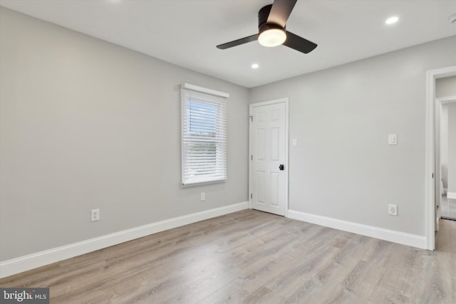 unfurnished bedroom with ceiling fan and light wood-type flooring