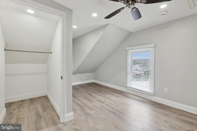 bonus room featuring ceiling fan, light wood-type flooring, and vaulted ceiling