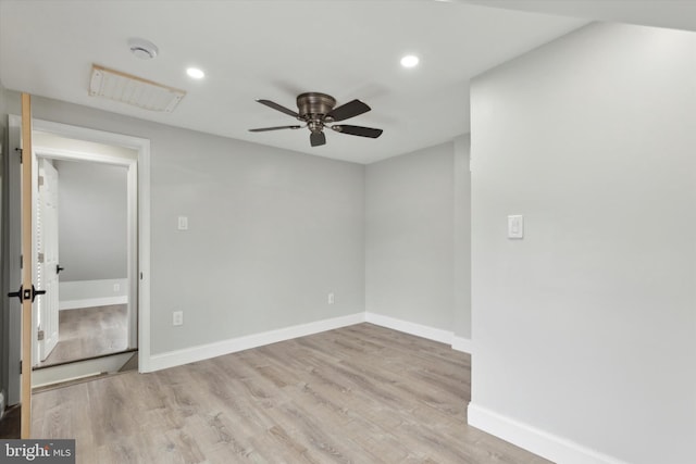 spare room with light hardwood / wood-style flooring and ceiling fan