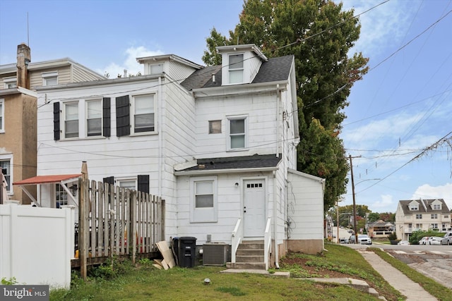 rear view of house with central AC