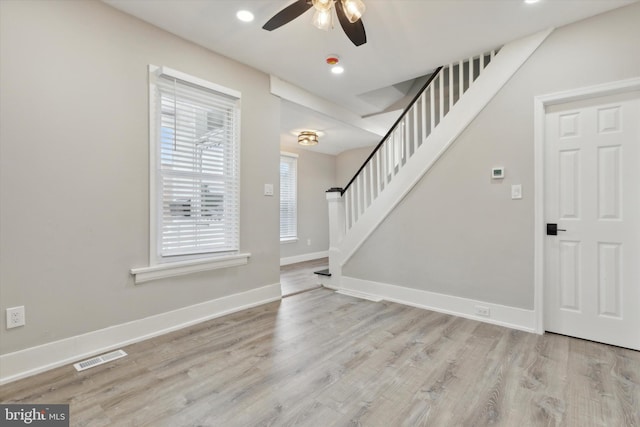 entryway with ceiling fan and light hardwood / wood-style flooring