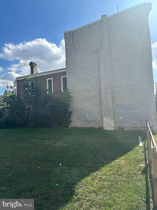 view of home's exterior with a yard