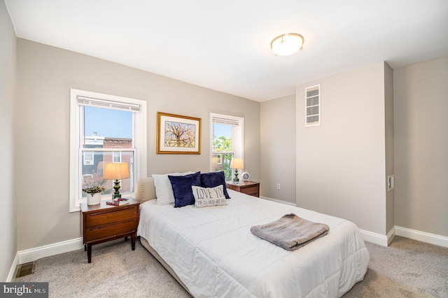 bedroom featuring light colored carpet