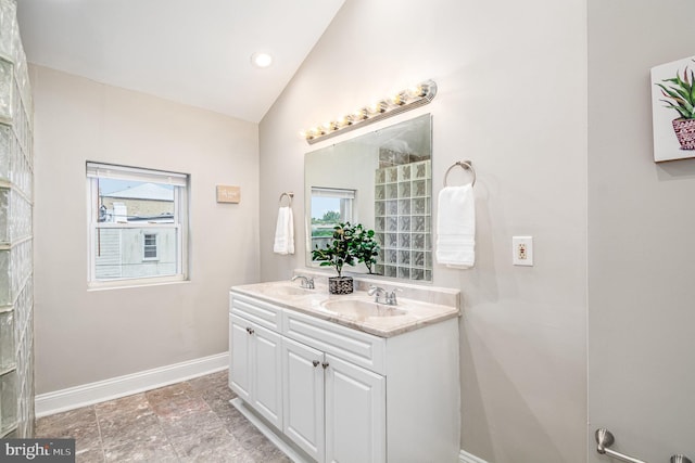 bathroom featuring lofted ceiling and vanity