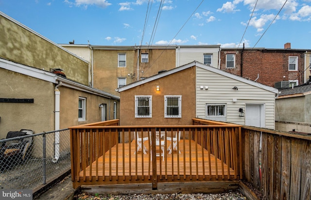 rear view of house featuring a wooden deck