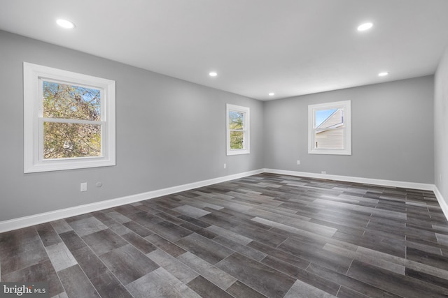 unfurnished room with dark wood-type flooring