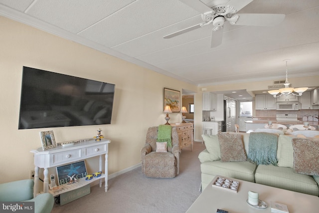 living room featuring crown molding, carpet, and ceiling fan