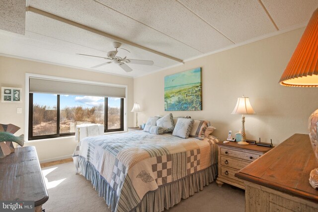 bedroom featuring a textured ceiling, ceiling fan, and light colored carpet