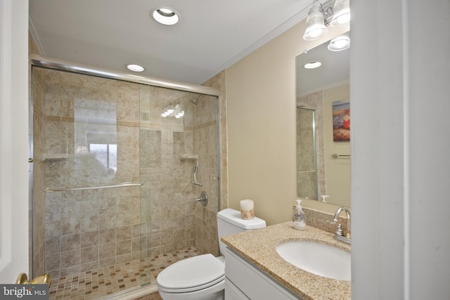 bathroom with ornamental molding, vanity, a shower with shower door, and toilet