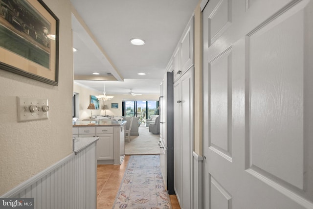 corridor featuring light tile patterned flooring