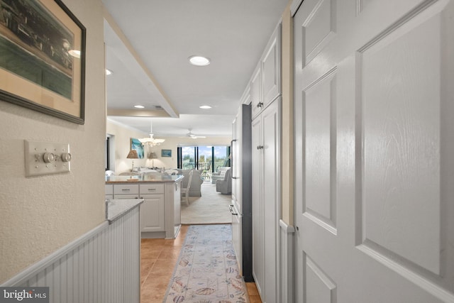 13700 Wight St Unit 1N01, Ocean City, MD 21842 - hallway with a decorative wall, light tile patterned floors, wainscoting, and recessed lighting