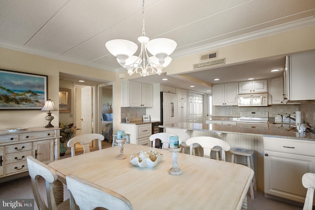 13700 Wight St Unit 1N01, Ocean City, MD 21842 - dining room with recessed lighting, a notable chandelier, and ornamental molding