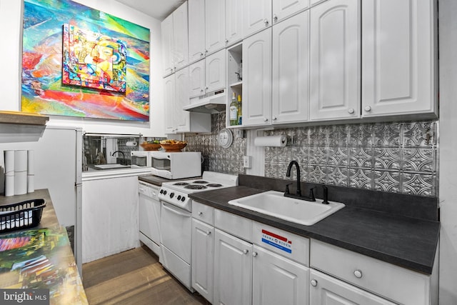 kitchen with sink, dark hardwood / wood-style flooring, white appliances, and white cabinetry