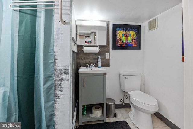 bathroom featuring a shower with shower curtain, tile patterned flooring, vanity, and toilet