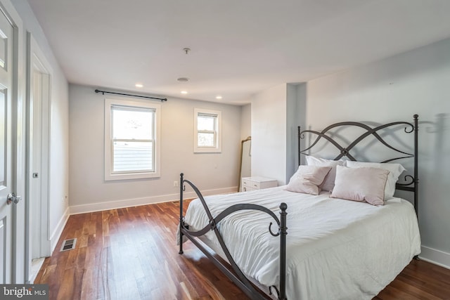 bedroom with dark hardwood / wood-style flooring