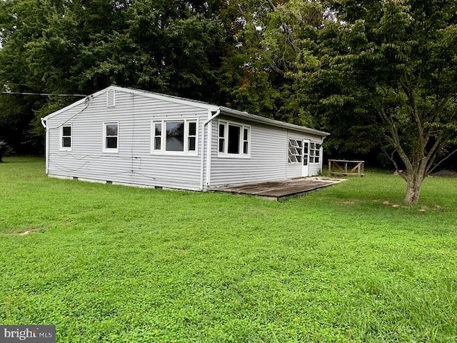 back of property featuring a lawn