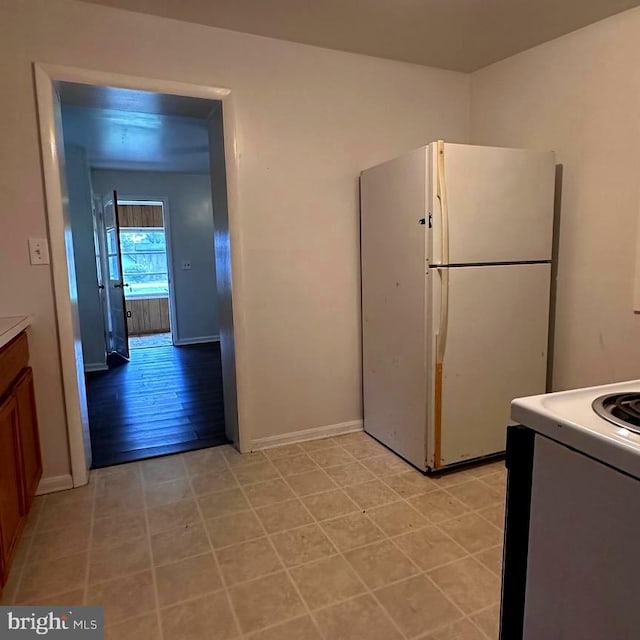 kitchen with light hardwood / wood-style flooring and white appliances