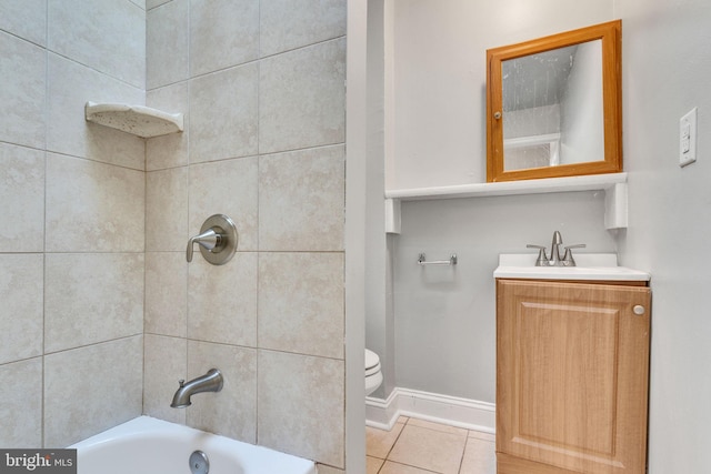 full bathroom with tiled shower / bath combo, vanity, tile patterned floors, and toilet