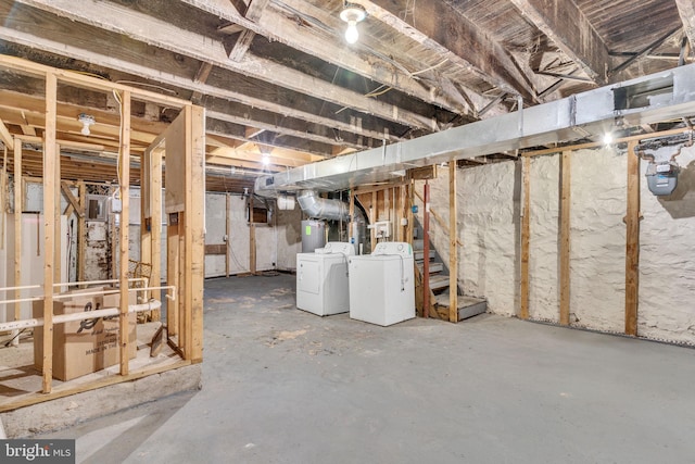 basement featuring separate washer and dryer and electric water heater