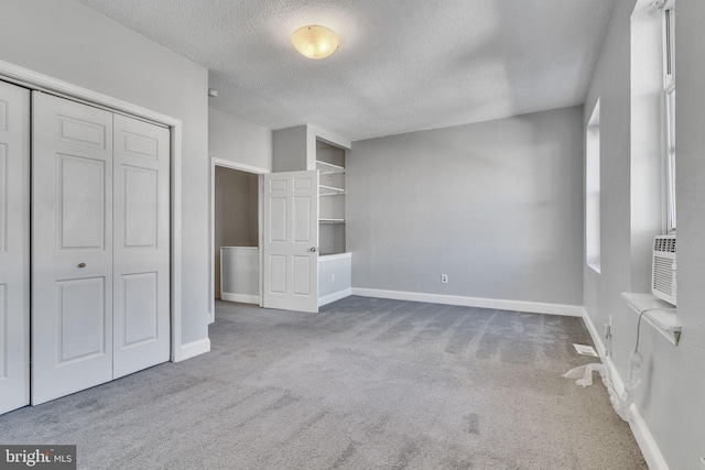 unfurnished bedroom with a closet, carpet floors, and a textured ceiling