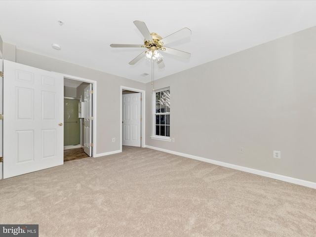 unfurnished bedroom featuring light colored carpet and ceiling fan