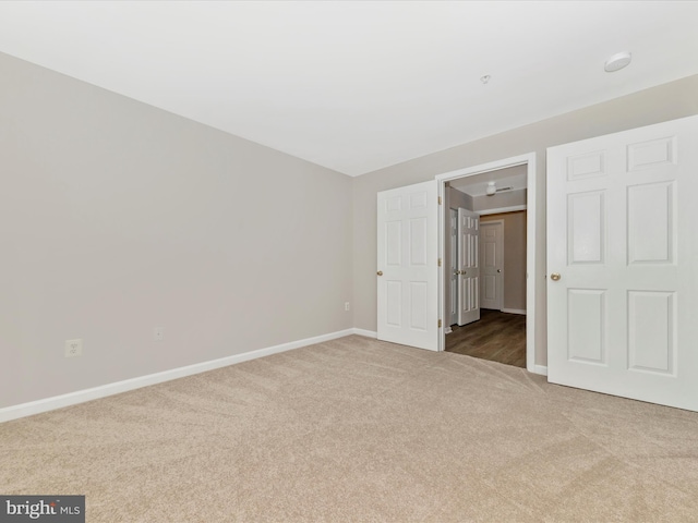 unfurnished room with light carpet