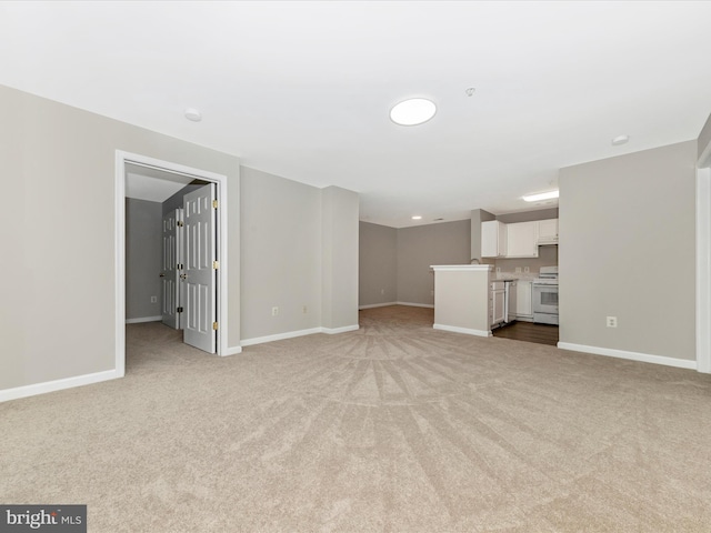 unfurnished living room with light carpet