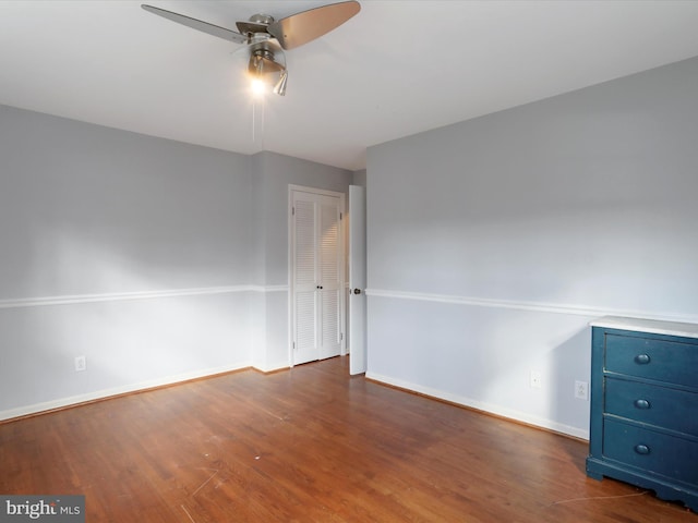 spare room with dark hardwood / wood-style flooring and ceiling fan