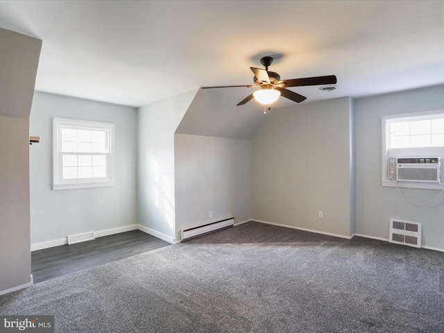 bonus room with baseboard heating, a wealth of natural light, cooling unit, and vaulted ceiling