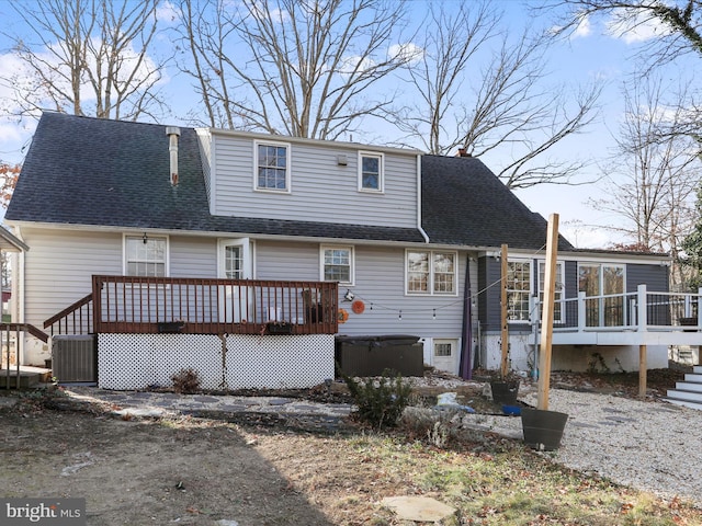 back of house featuring a wooden deck and central AC