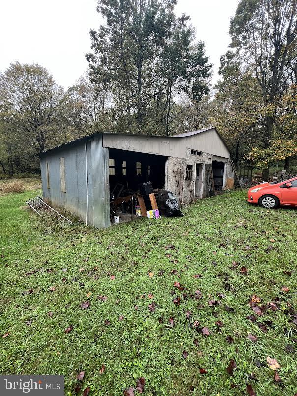 view of outbuilding with a lawn