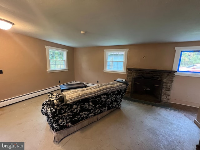 bedroom featuring concrete floors, a fireplace, and multiple windows