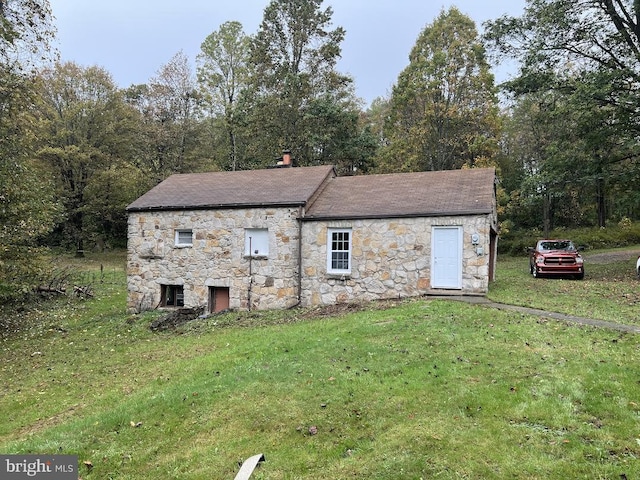 view of property exterior with a lawn