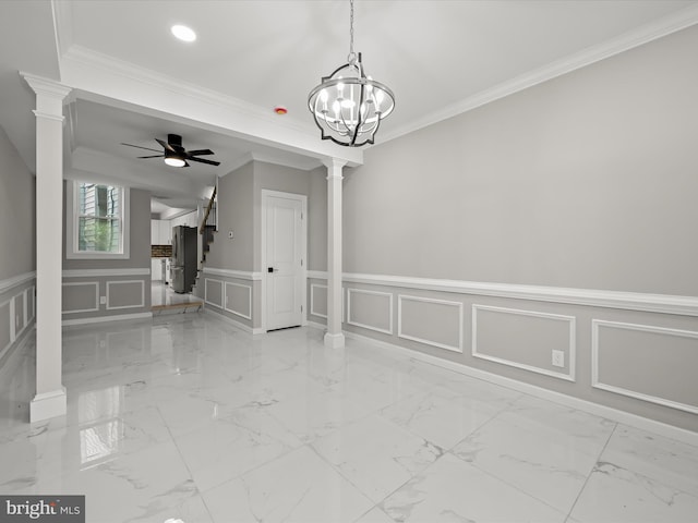 empty room featuring ornate columns, ceiling fan with notable chandelier, and ornamental molding