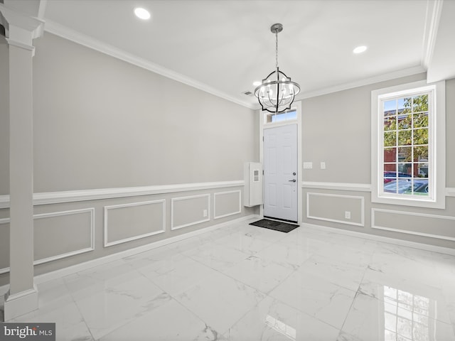 unfurnished dining area with an inviting chandelier, decorative columns, and ornamental molding