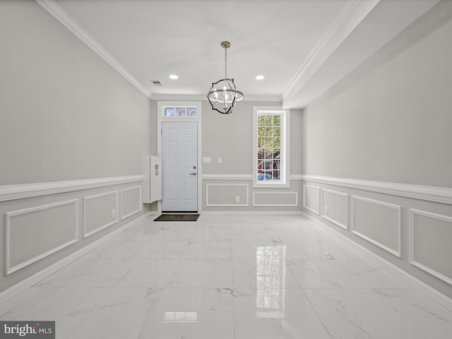 interior space with a notable chandelier and crown molding